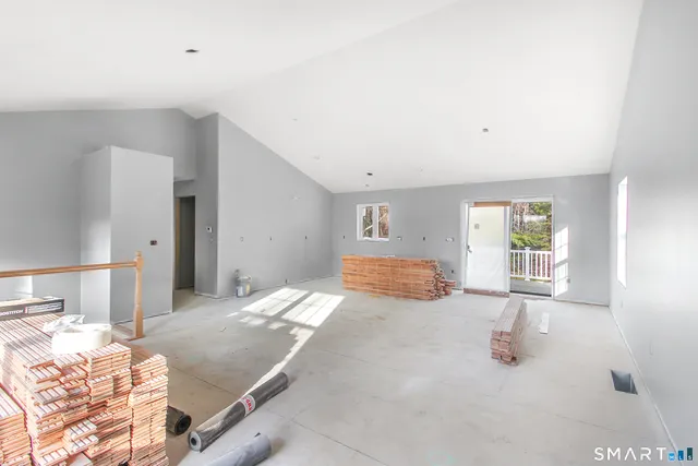 a view of a bedroom with a bed and wooden floor
