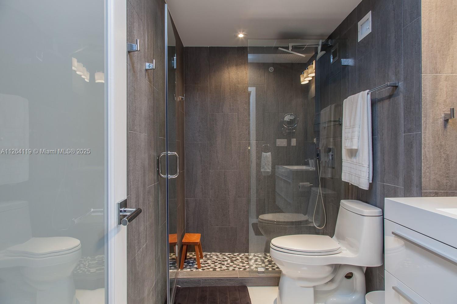 100 Lincoln Road, Unit 943 Miami Beach, FL 33139 - Photo 16 of 56 a bathroom with a toilet a sink and shower