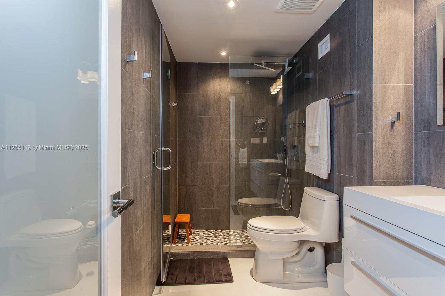 100 Lincoln Road, Unit 943 Miami Beach, FL 33139 - Photo 17 of 56 a bathroom with a toilet a sink and shower