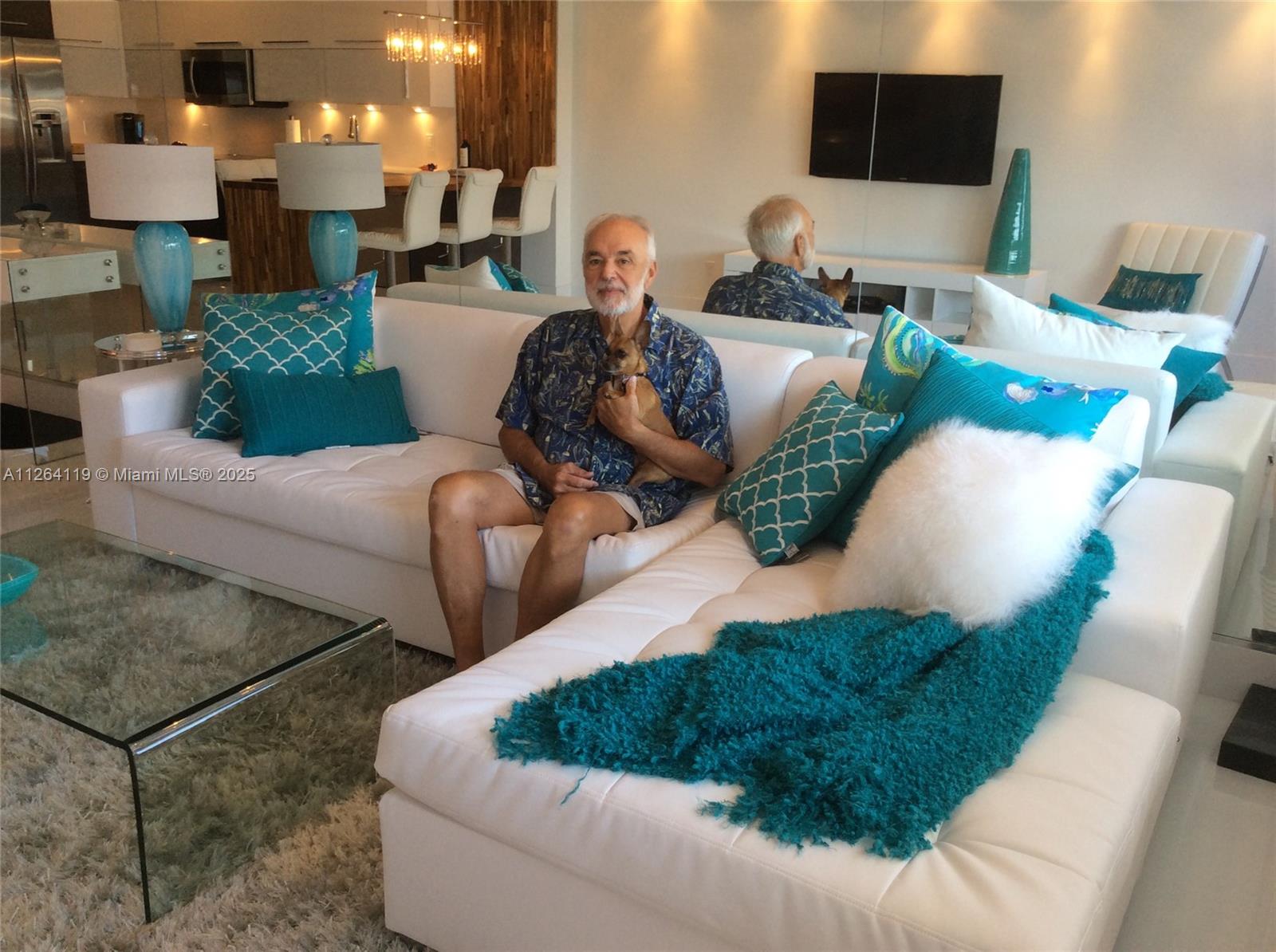 100 Lincoln Road, Unit 943 Miami Beach, FL 33139 - Photo 19 of 56 a living room with furniture and a flat screen tv