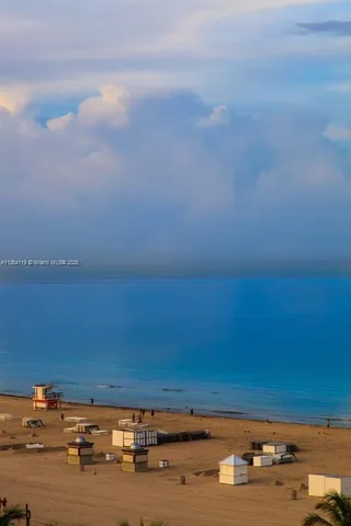 a kitchen with kitchen island granite countertop a sink cabinets and stainless steel appliances
