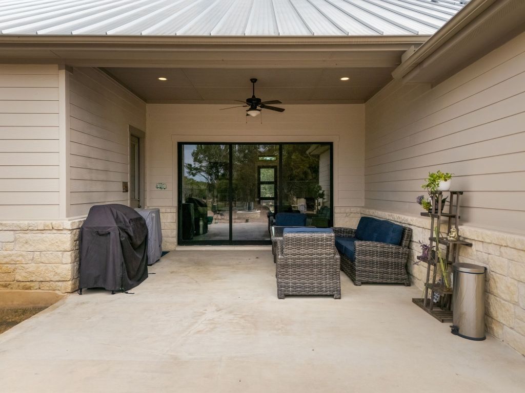 2140 Carpenter Loop Burnet, TX 78611 - Photo 27 of 40 a living room with furniture a fireplace and potted plants