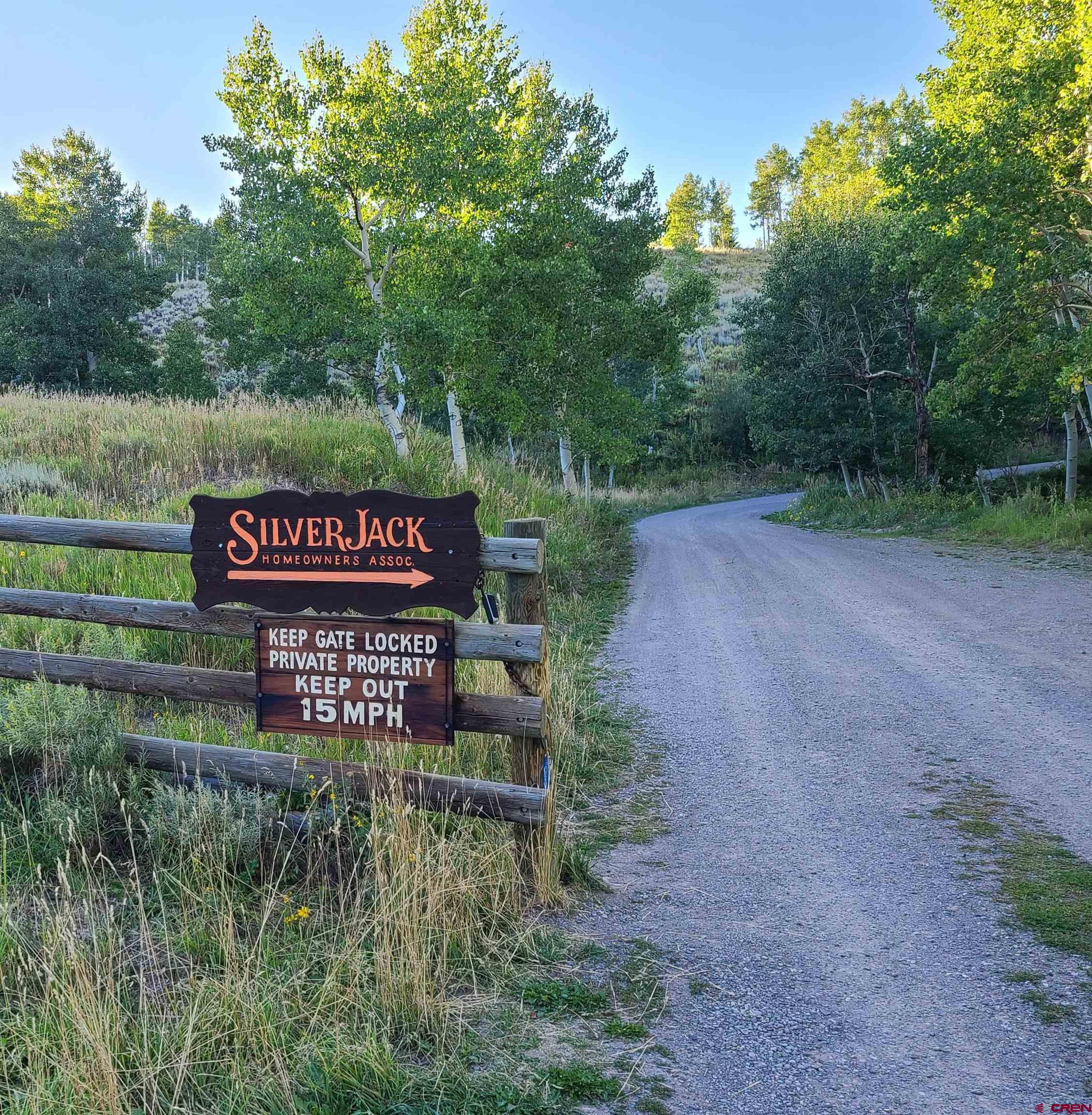 704 Hampton Road Montrose, CO 81220 - Photo 41 of 45 a sign that is sitting in the middle of a forest