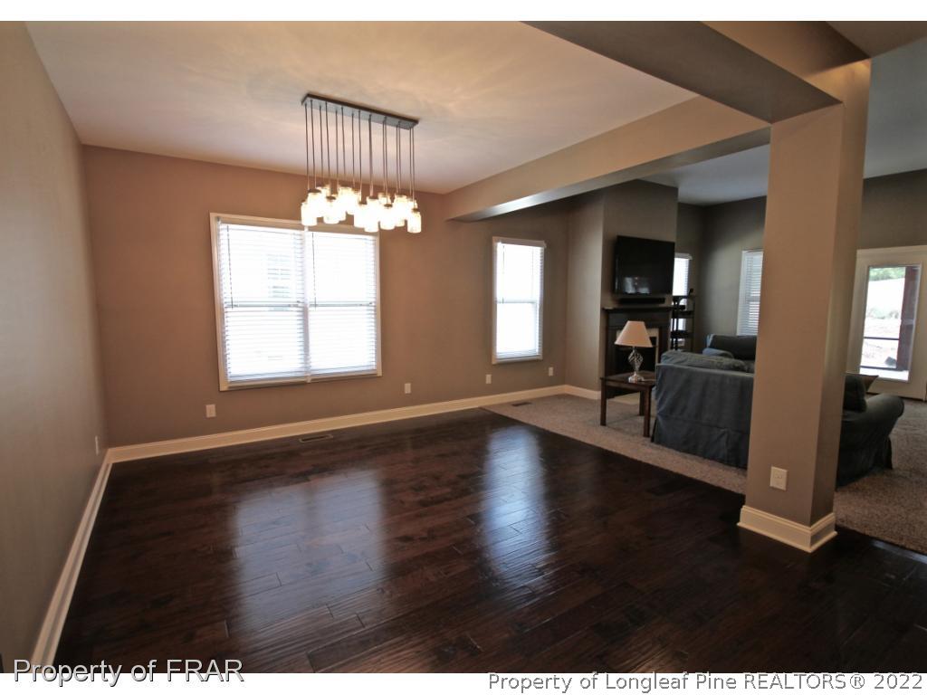 309 Duncan Road Southern Pines, NC 28387 - Photo 13 of 36 an empty room with wooden floor and windows