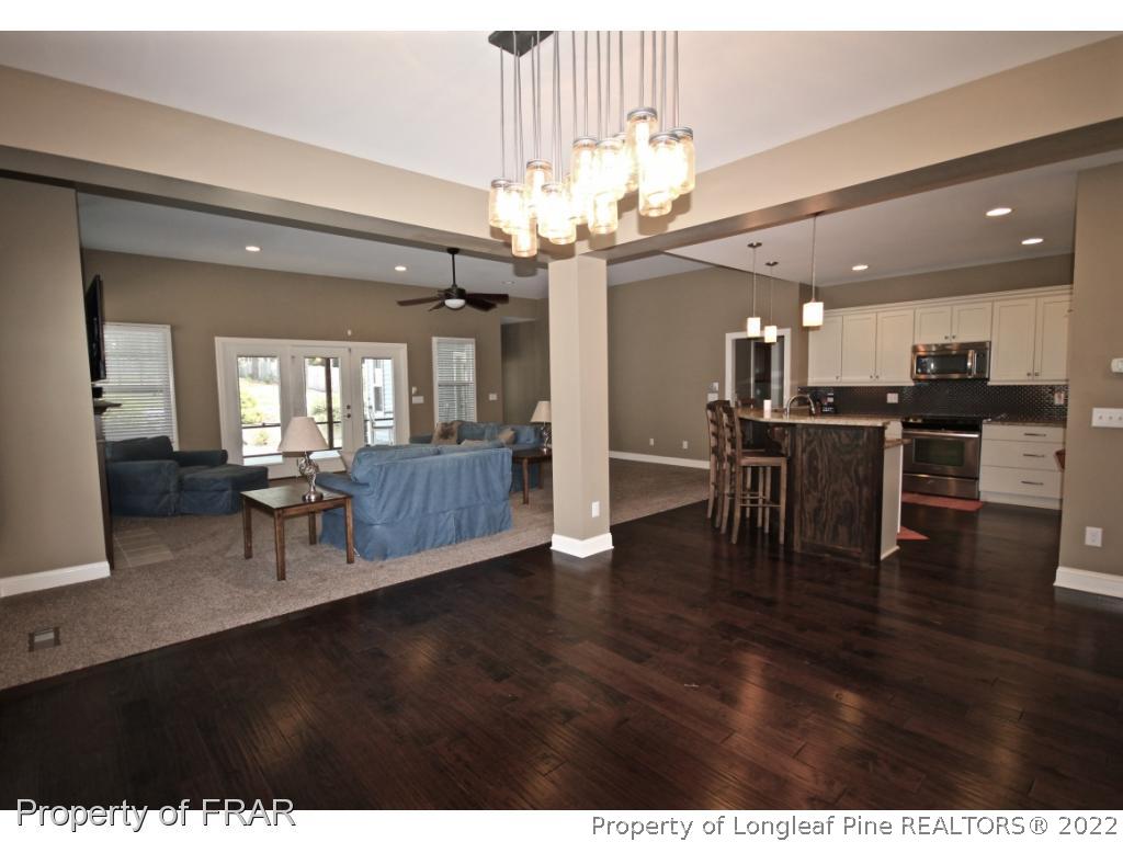 309 Duncan Road Southern Pines, NC 28387 - Photo 15 of 36 a view of a dining room with furniture a chandelier and wooden floor