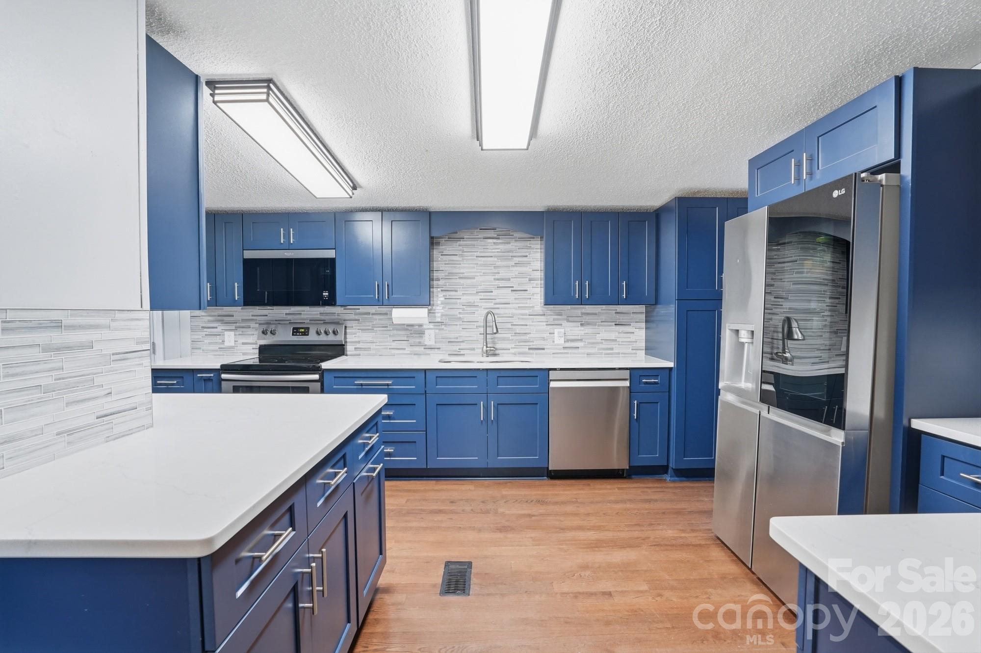 605 Ridgewood Court Mount Holly, NC 28120 - Photo 2 of 32 a kitchen with stainless steel appliances granite countertop a sink stove microwave and refrigerator