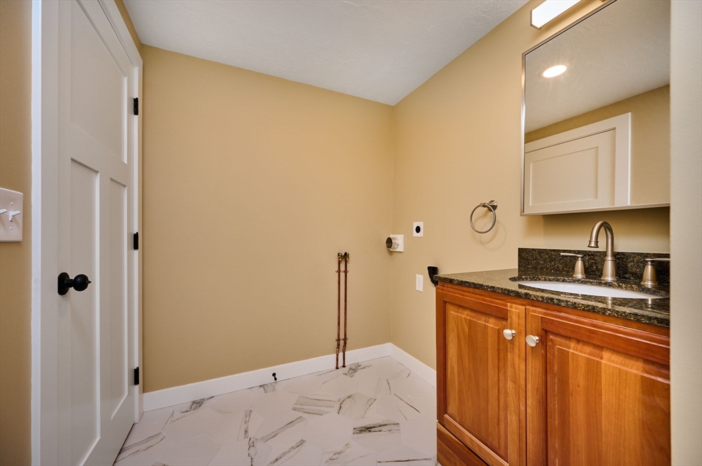 74 Lead Mine Road Southampton, MA 01073 - Photo 11 of 34 a kitchen with stainless steel appliances granite countertop a sink and cabinets