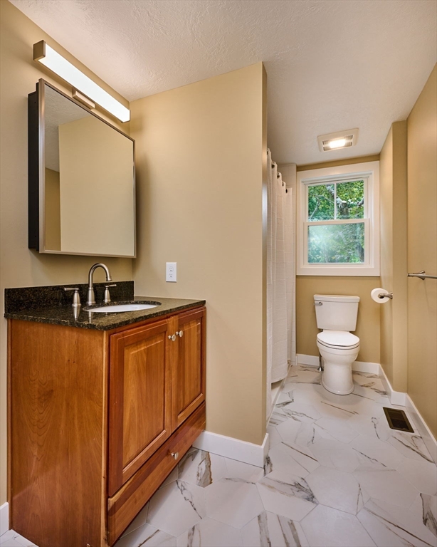 74 Lead Mine Road Southampton, MA 01073 - Photo 10 of 34 a bathroom with a toilet sink and mirror