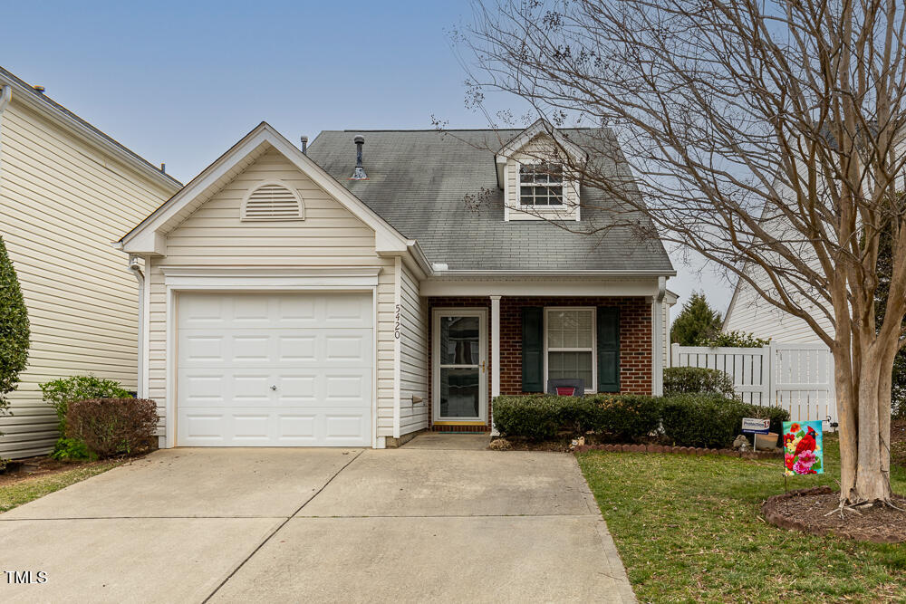 5420 Golden Moss Trail Raleigh, NC 27613 - Photo 1 of 33 a view of a white house with large windows and a small yard