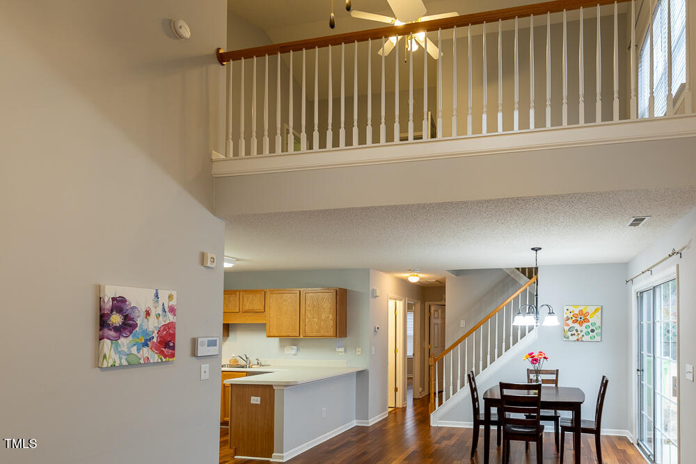 5420 Golden Moss Trail Raleigh, NC 27613 - Photo 13 of 33 a view of a hallway with furniture and a kitchen