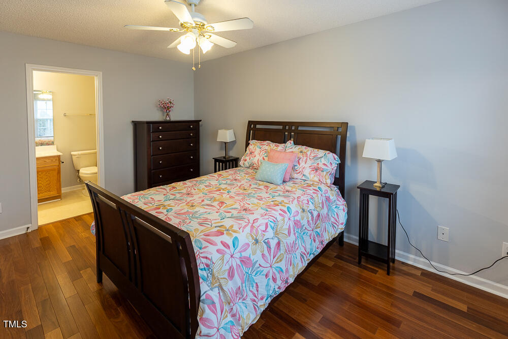 5420 Golden Moss Trail Raleigh, NC 27613 - Photo 15 of 33 a bedroom with a bed and wooden floor