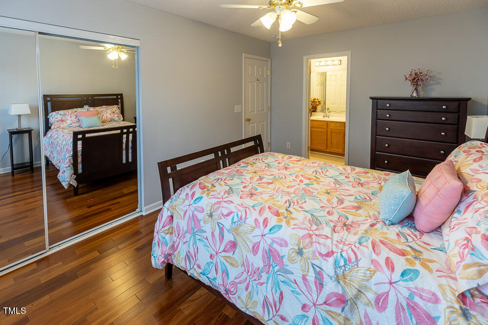 5420 Golden Moss Trail Raleigh, NC 27613 - Photo 16 of 33 a bedroom with a bed and wooden floor