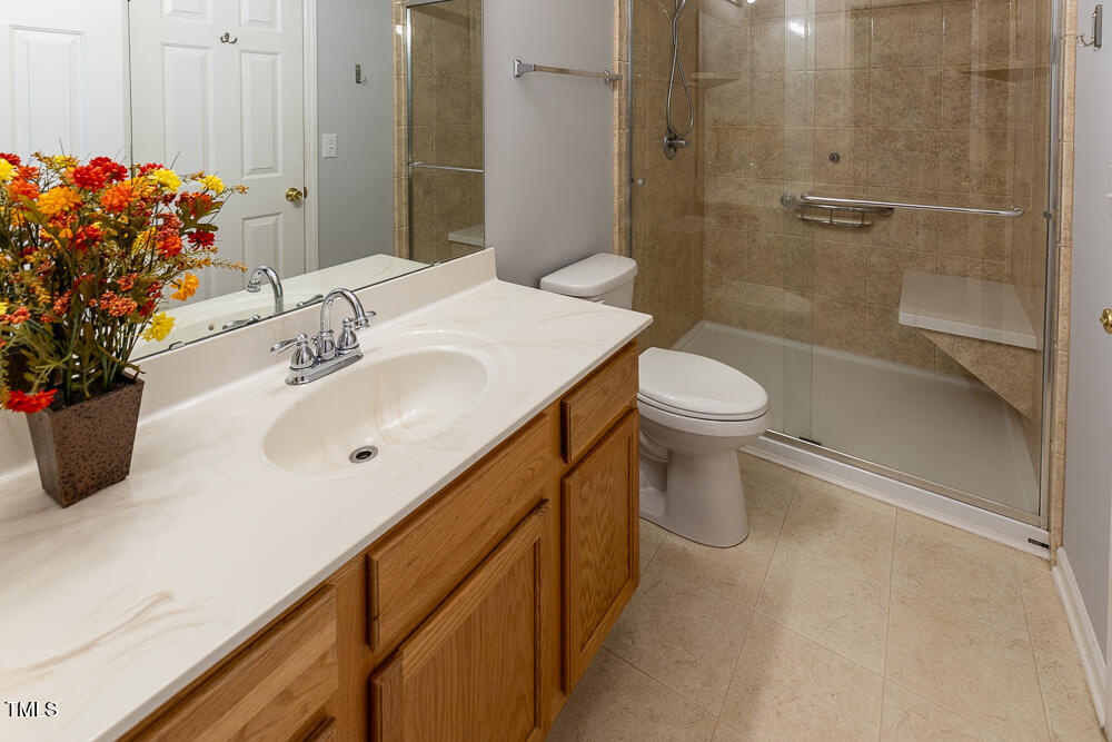 5420 Golden Moss Trail Raleigh, NC 27613 - Photo 17 of 33 a bathroom with a sink toilet and shower