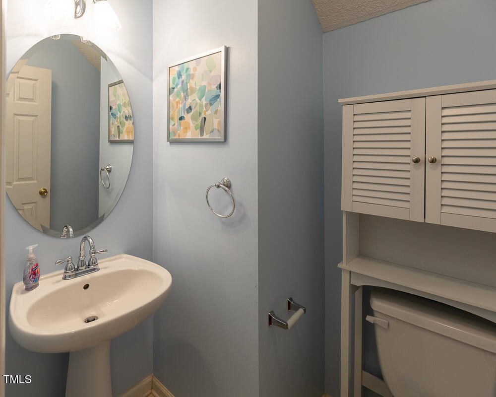 5420 Golden Moss Trail Raleigh, NC 27613 - Photo 20 of 33 a bathroom with a sink and mirror