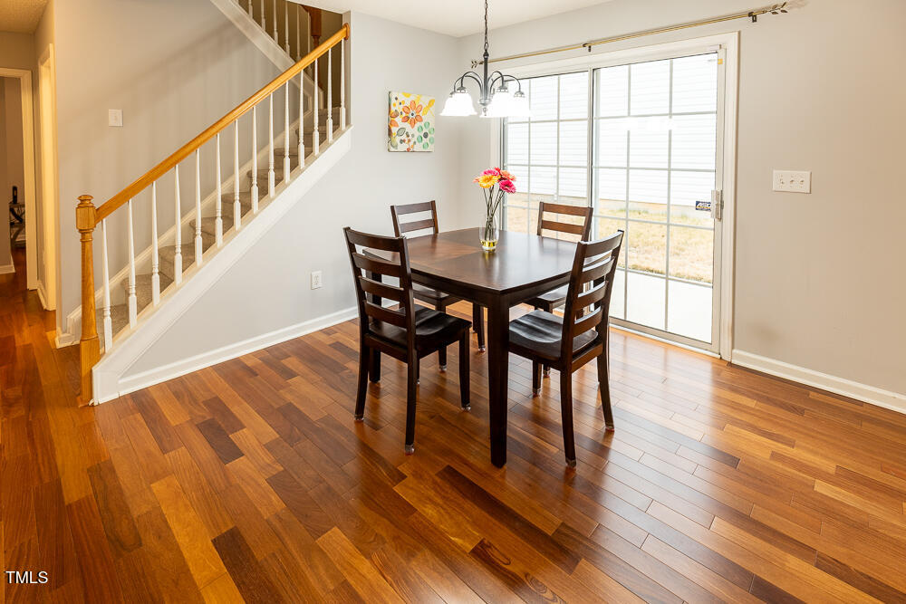 5420 Golden Moss Trail Raleigh, NC 27613 - Photo 8 of 33 a view of a dining room with furniture and wooden floor