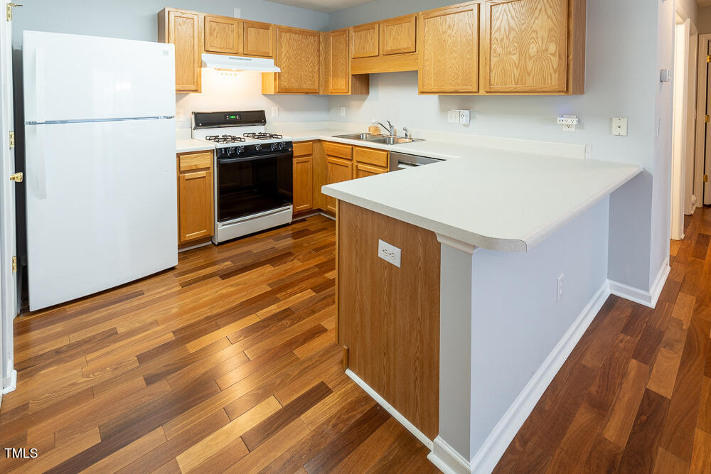 5420 Golden Moss Trail Raleigh, NC 27613 - Photo 9 of 33 a kitchen with a refrigerator and a sink