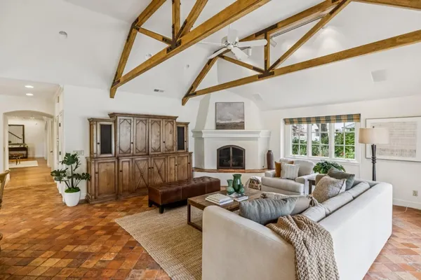 a living room with furniture a fireplace and a flat screen tv