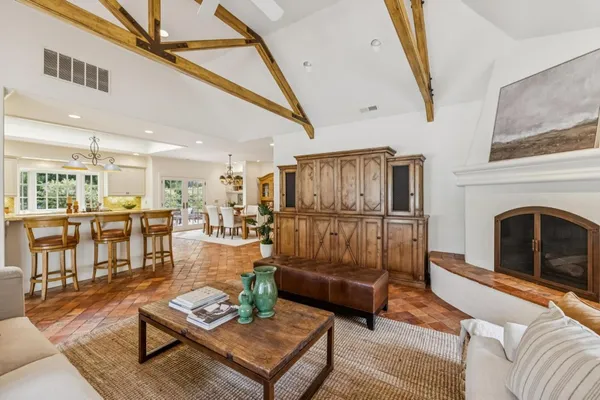a living room with furniture ceiling fan and a rug