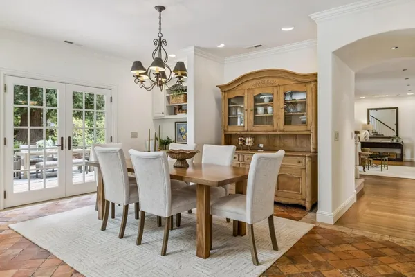 a view of a a dining room with furniture window and wooden floor