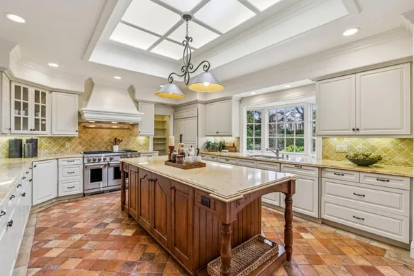 a kitchen with stainless steel appliances granite countertop a stove oven and a refrigerator