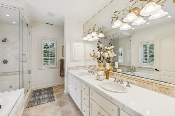 a bathroom with a tub sink and mirror