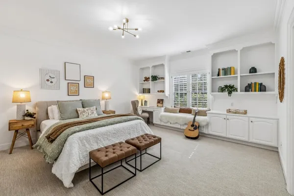 a spacious bedroom with a bed and a couch