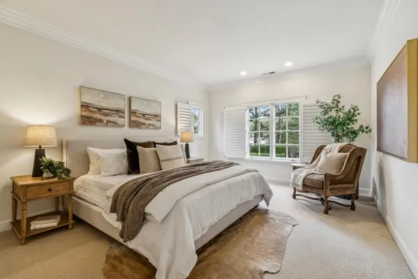 a spacious bedroom with a bed and a couch