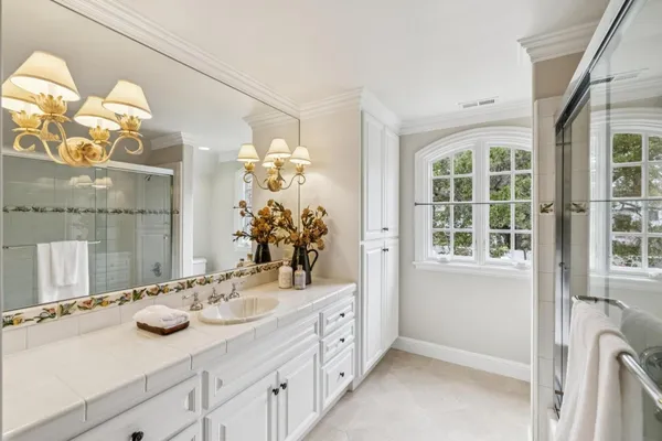 a bathroom with a sink a vanity and a mirror
