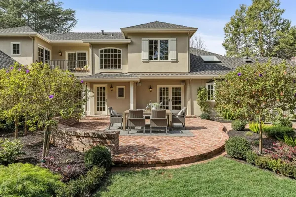 a view of a house with backyard porch and sitting area