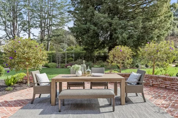 a view of a patio with a table and chairs