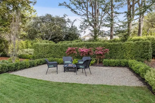 a view of a chairs and table in the garden
