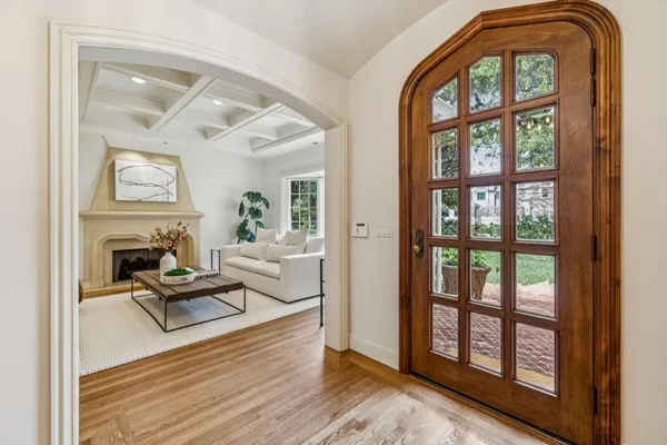a living room with furniture and floor to ceiling windows