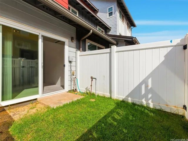 a view of an house with backyard and porch