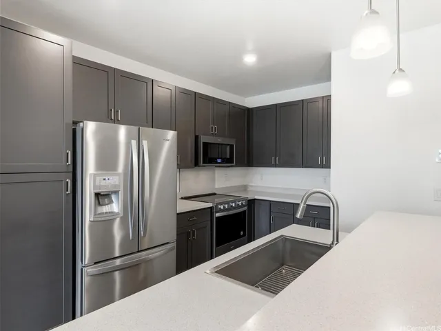 a kitchen with a refrigerator sink and microwave