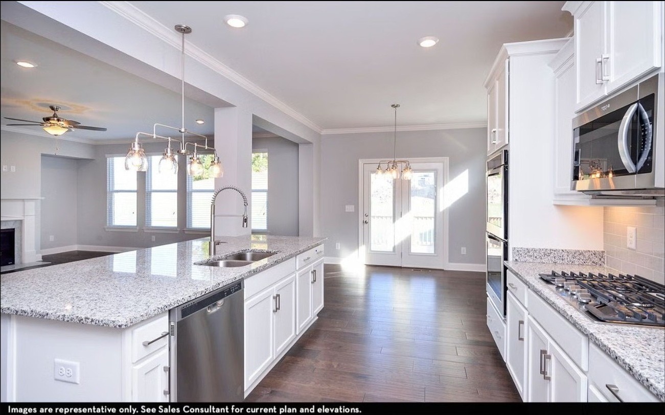 7914 Pine Street Fairview, TN 37062 - Photo 12 of 22 a kitchen with stainless steel appliances granite countertop a sink stove and cabinets