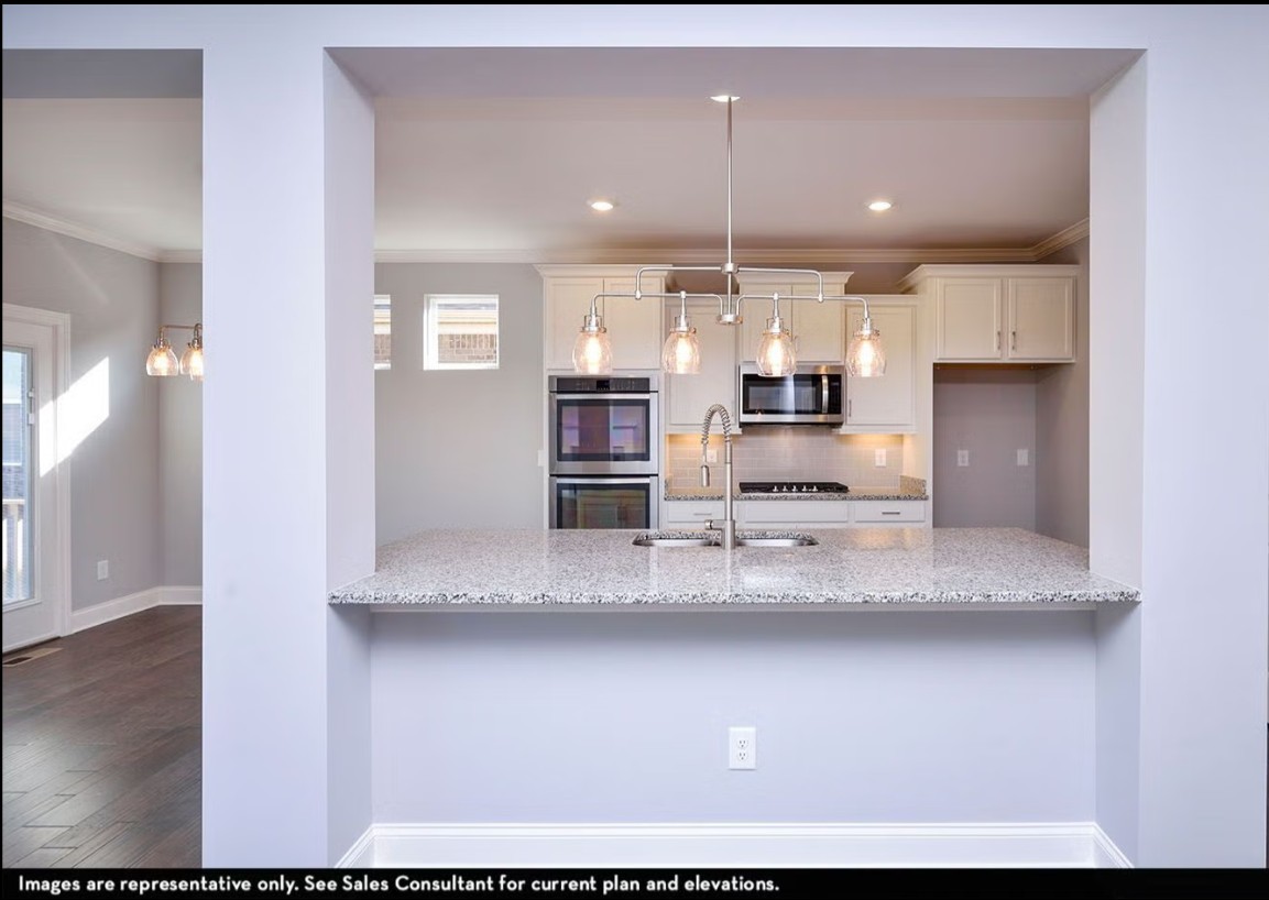 7914 Pine Street Fairview, TN 37062 - Photo 14 of 22 a view of kitchen with center island wooden floor and living room view