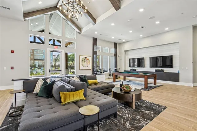 a living room with furniture and wooden floor