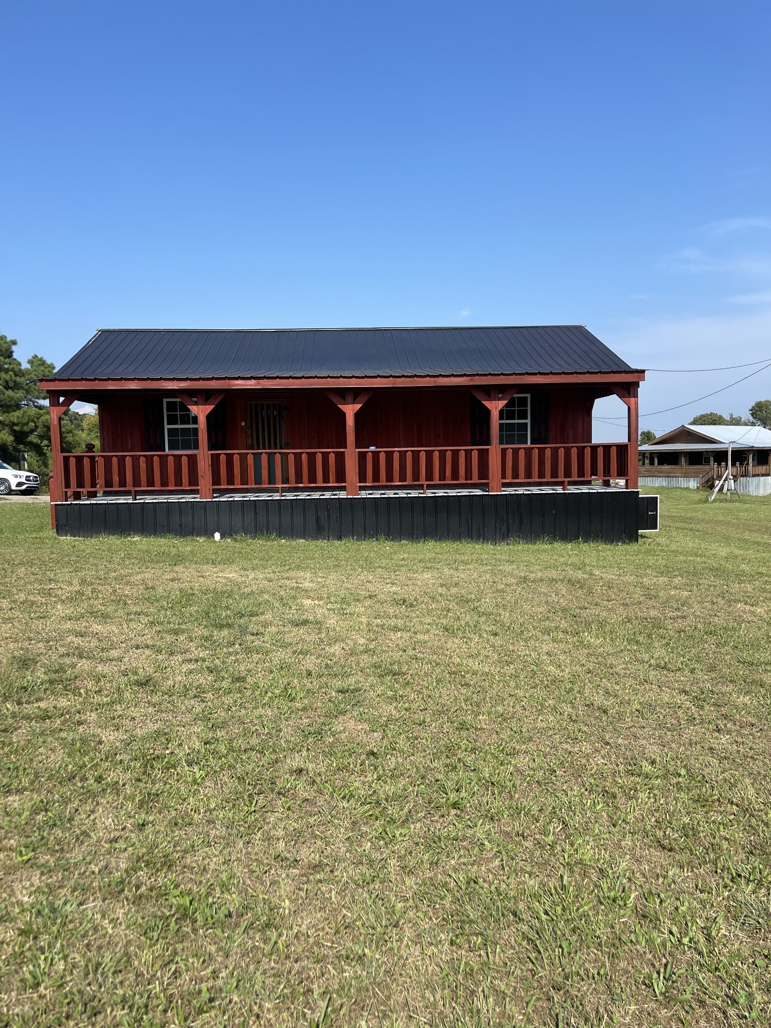 3141 Oak Grove Road Red Boiling Springs, TN 37150 - Photo 1 of 14 a large pool with lawn chairs and a table under an umbrella