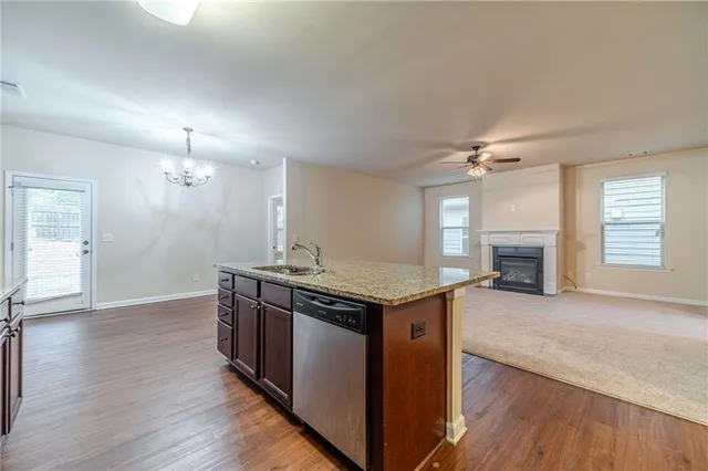 a kitchen with a stove and a wooden floors