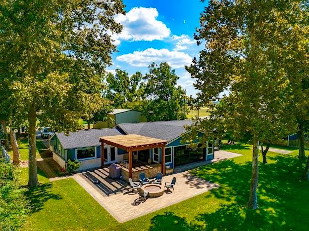 1017 Airport Road Graford, TX 76449 - Photo 1 of 32 a view of a patio with table and chairs potted plants and large tree