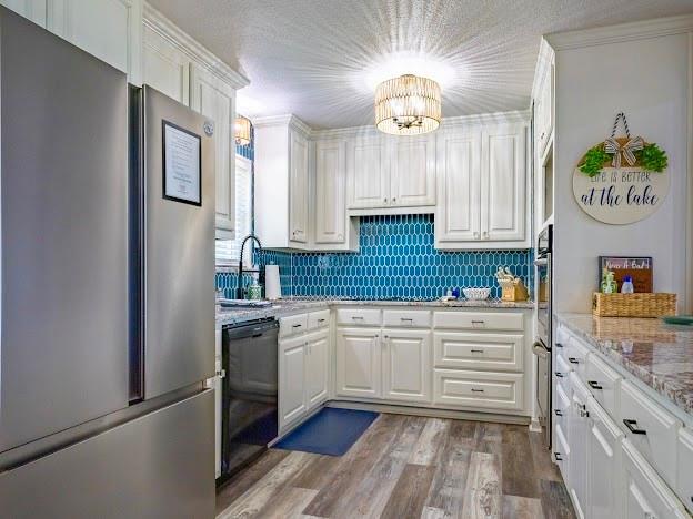 1017 Airport Road Graford, TX 76449 - Photo 15 of 32 a kitchen with granite countertop stainless steel appliances a stove refrigerator and cabinets