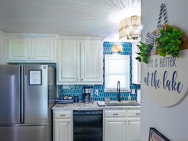 1017 Airport Road Graford, TX 76449 - Photo 17 of 32 a kitchen with stainless steel appliances granite countertop a refrigerator sink and cabinets