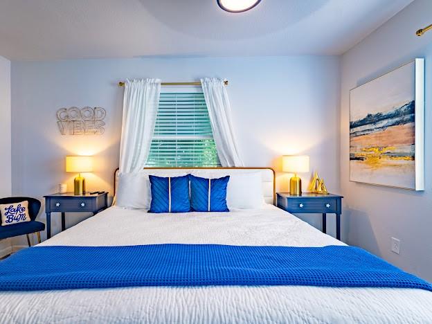 1017 Airport Road Graford, TX 76449 - Photo 20 of 32 a bedroom with a bed and wooden floor