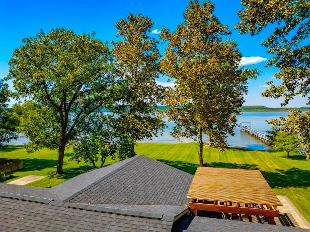 1017 Airport Road Graford, TX 76449 - Photo 2 of 32 a view of a patio with table and chairs and a large tree