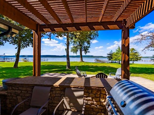 1017 Airport Road Graford, TX 76449 - Photo 29 of 32 a view of a patio with a table chairs and a backyard