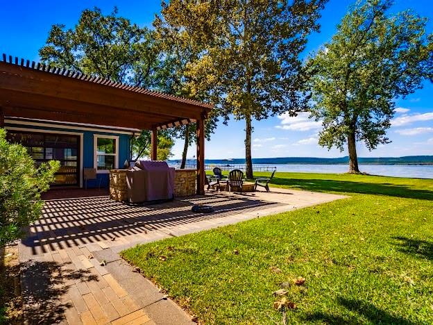 1017 Airport Road Graford, TX 76449 - Photo 31 of 32 a view of a house with backyard porch and sitting area
