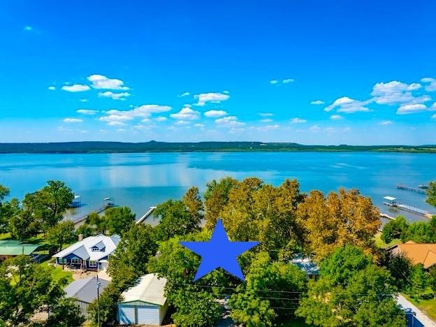 1017 Airport Road Graford, TX 76449 - Photo 32 of 32 a view of a lake with a house in a big yard
