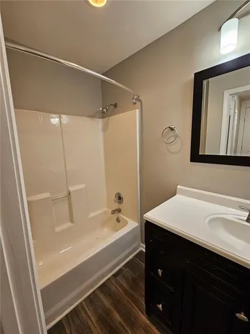 a bathroom with a bathtub and a sink