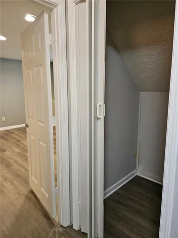 a view of a hallway with wooden floor