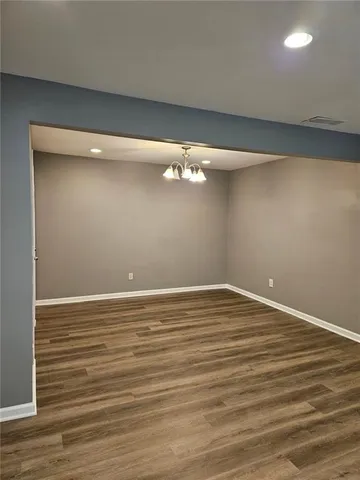 a view of a room with wooden floor and cabinet